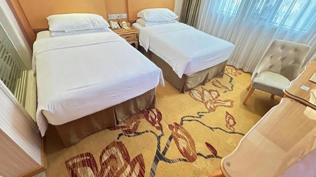 Bed in Vienna Hotel Guangxi Beiliu Passenger Station