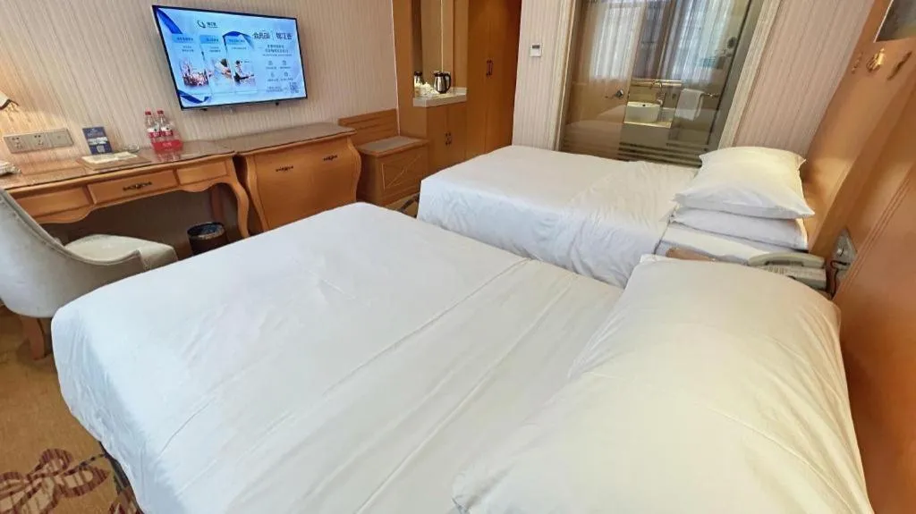 Bed in Vienna Hotel Guangxi Beiliu Passenger Station