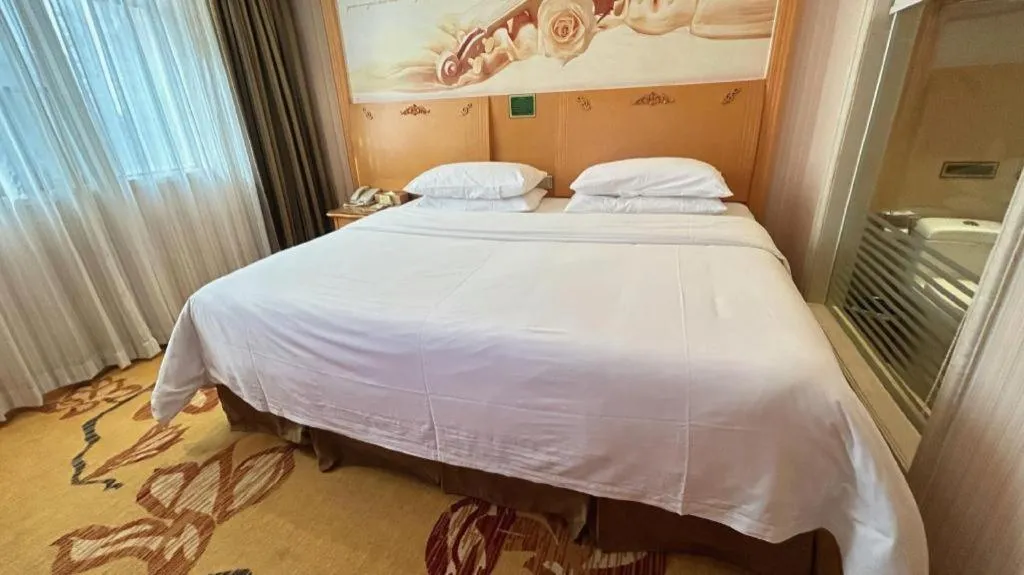 Bed in Vienna Hotel Guangxi Beiliu Passenger Station