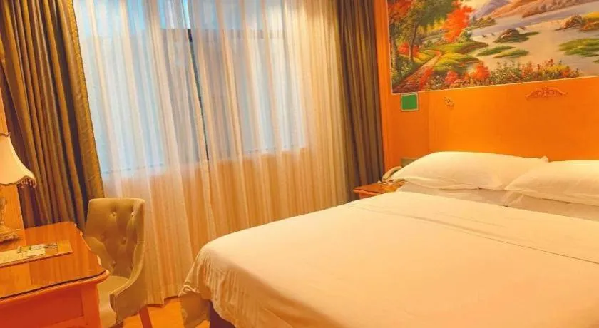 Bed in Vienna Hotel Guangxi Beiliu Passenger Station