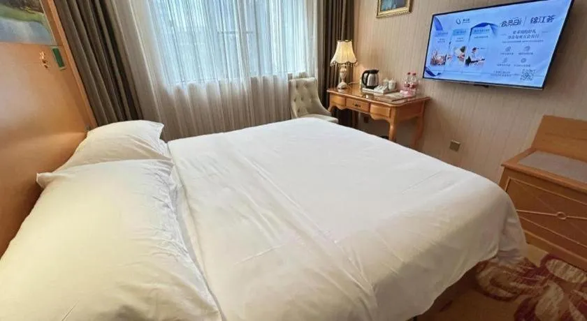 Bed in Vienna Hotel Guangxi Beiliu Passenger Station