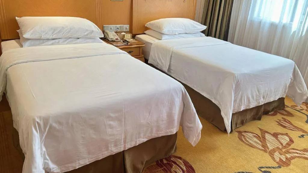 Bed in Vienna Hotel Guangxi Beiliu Passenger Station