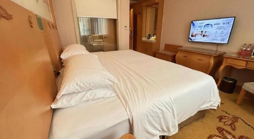 Bed in Vienna Hotel Guangxi Beiliu Passenger Station