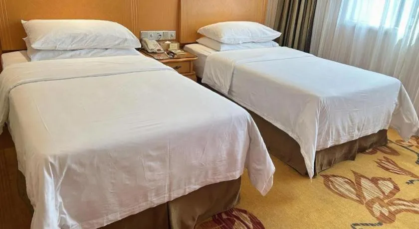 Bed in Vienna Hotel Guangxi Beiliu Passenger Station