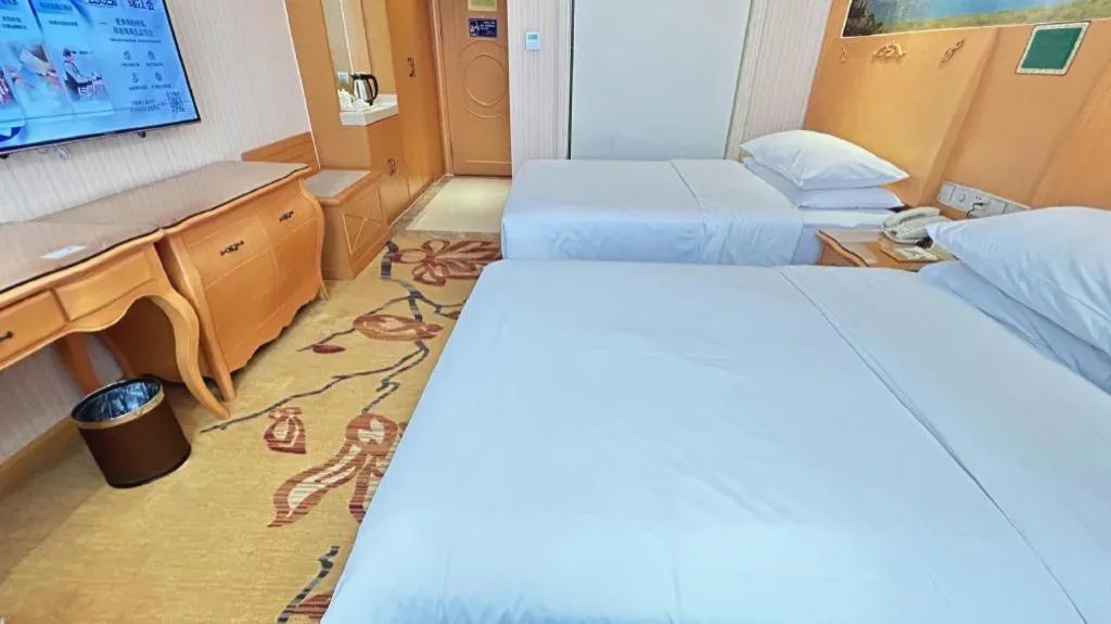 Bed in Vienna Hotel Guangxi Beiliu Passenger Station