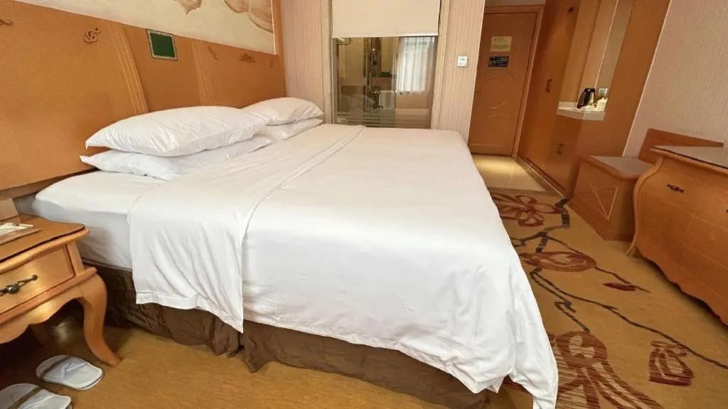 Bed in Vienna Hotel Guangxi Beiliu Passenger Station