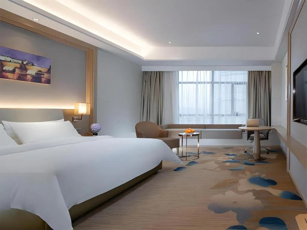 Bed in Vienna Hotel Xinfeng West High-Speed Railway Station