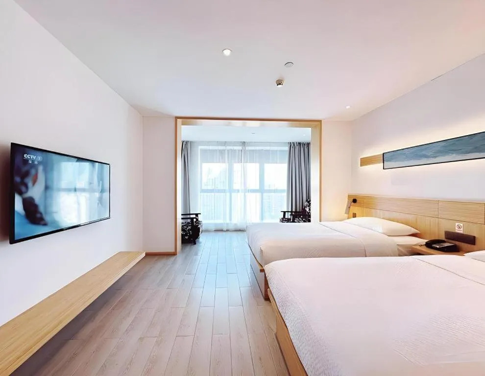 Bed in Meijin All Suites Hotel Suzhou