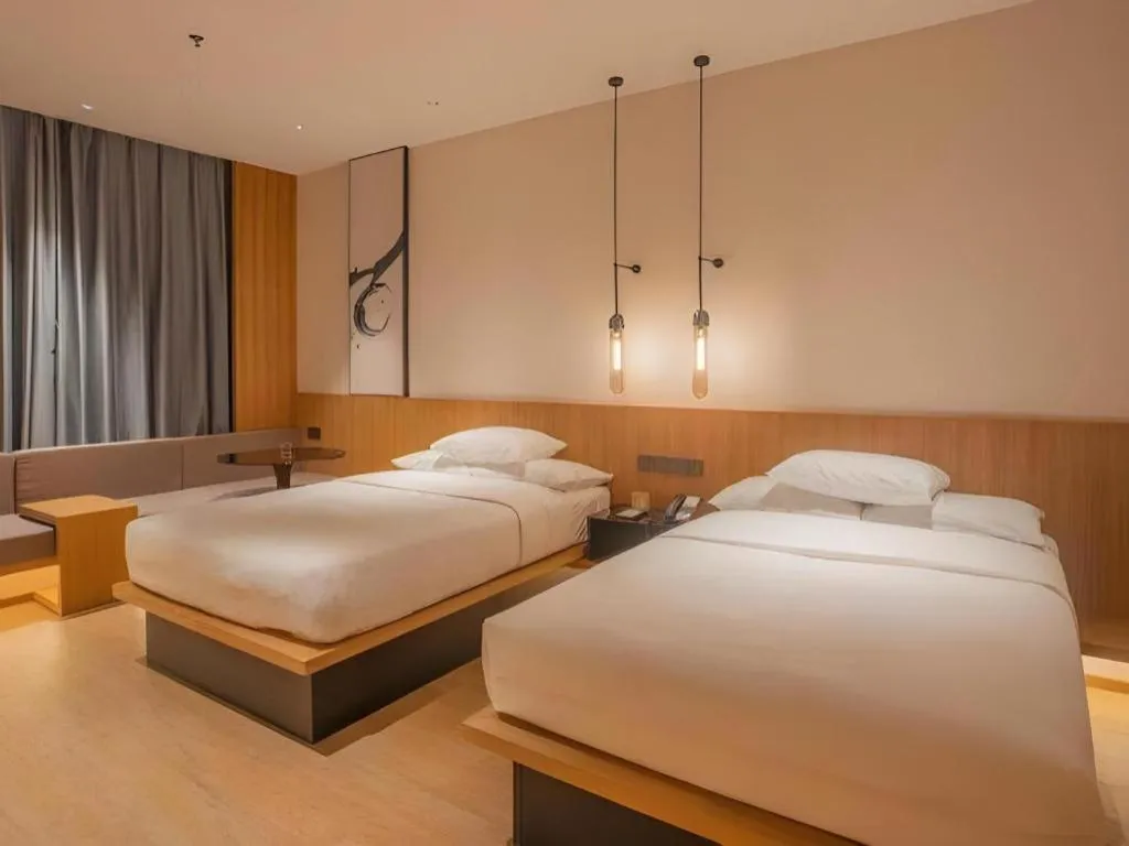 Bed in Meijin All Suites Hotel Suzhou