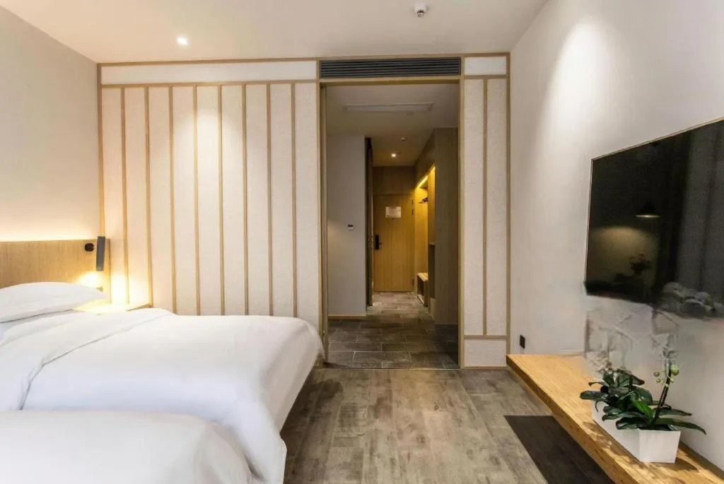 Bed in Meijin All Suites Hotel Suzhou