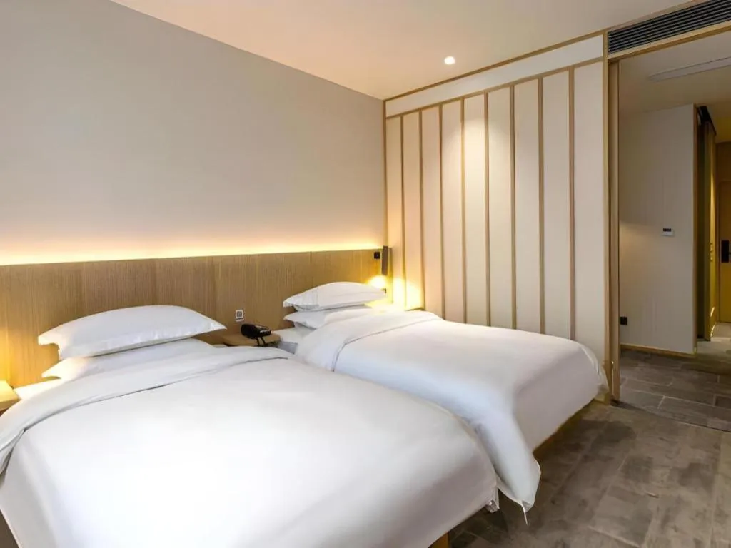 Bed in Meijin All Suites Hotel Suzhou