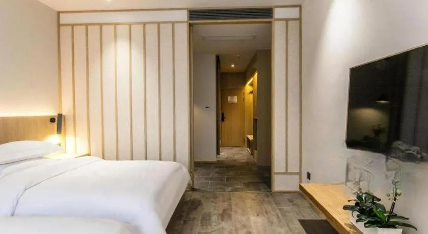 Bed in Meijin All Suites Hotel Suzhou