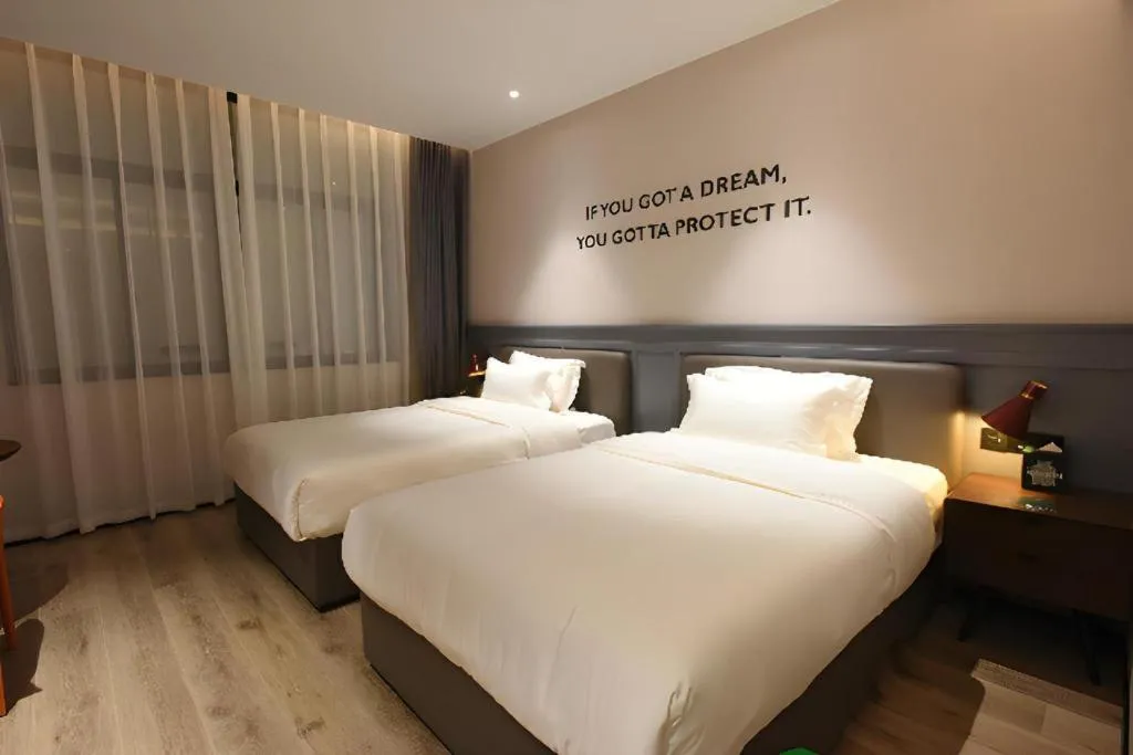 Bed in Premier City Comfort Hotel Hechi Luocheng Central Plaza