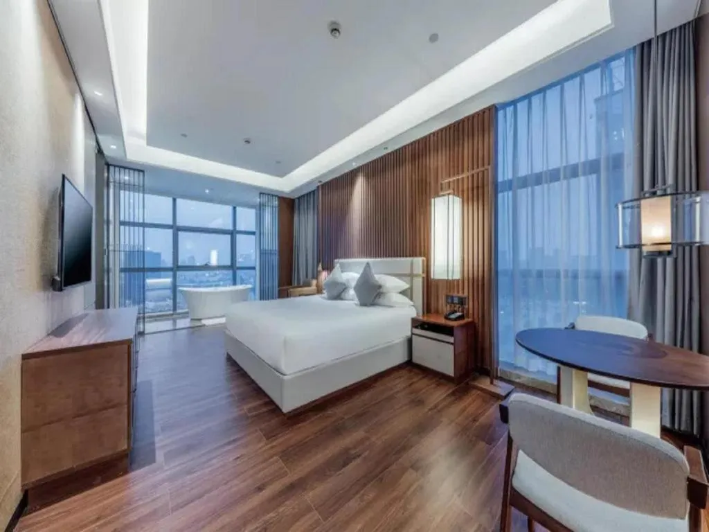Bed in New Century Grand Hotel Ningbo Zhongdu