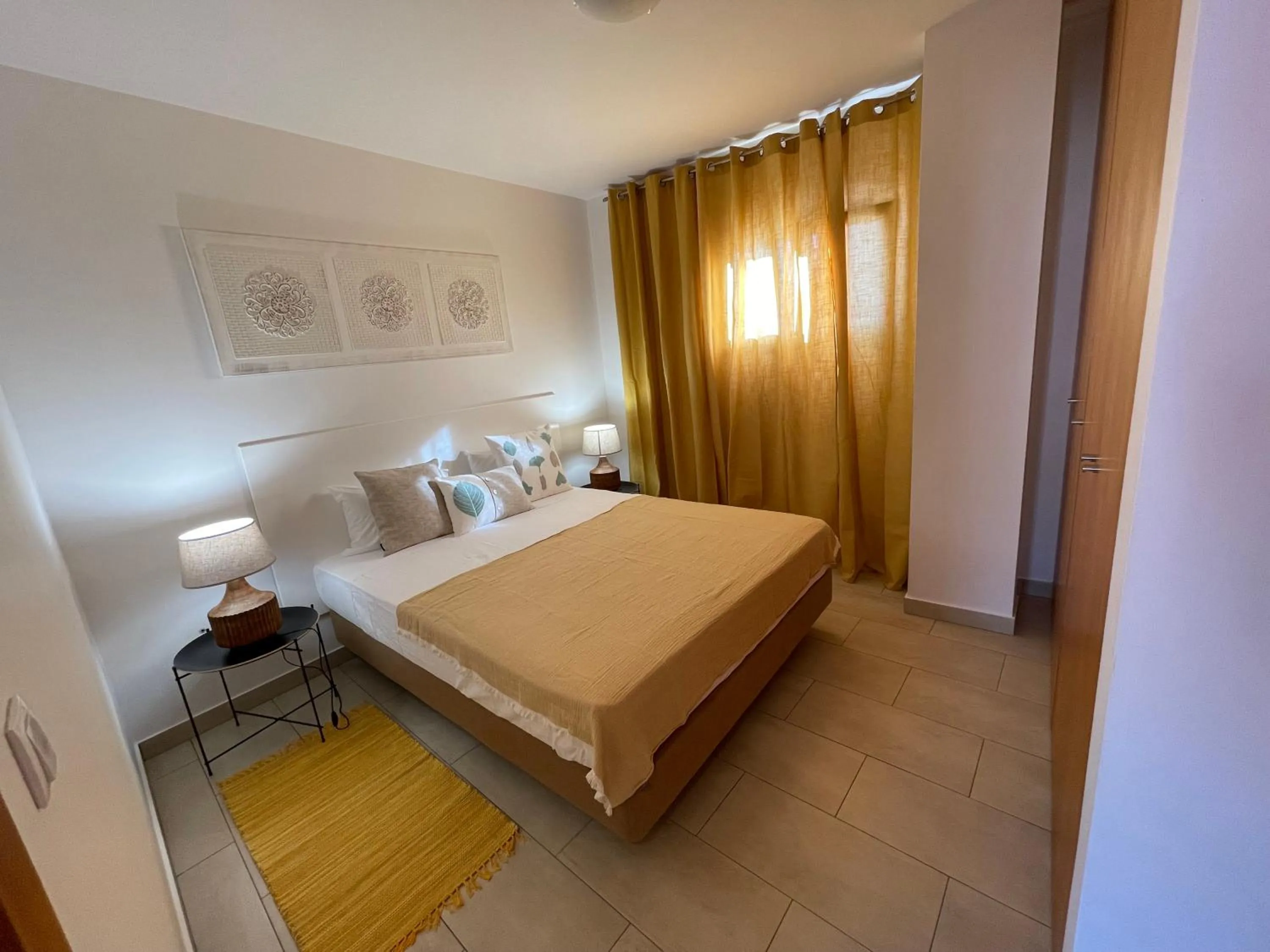 Bed in Esmeralda Holidays Apartments