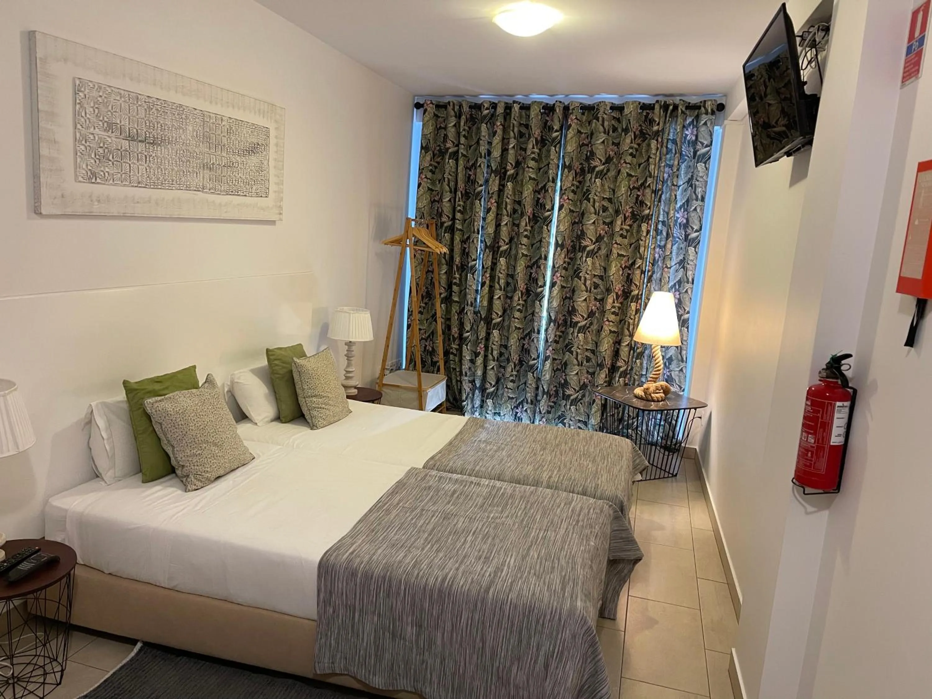 Bed in Esmeralda Holidays Apartments