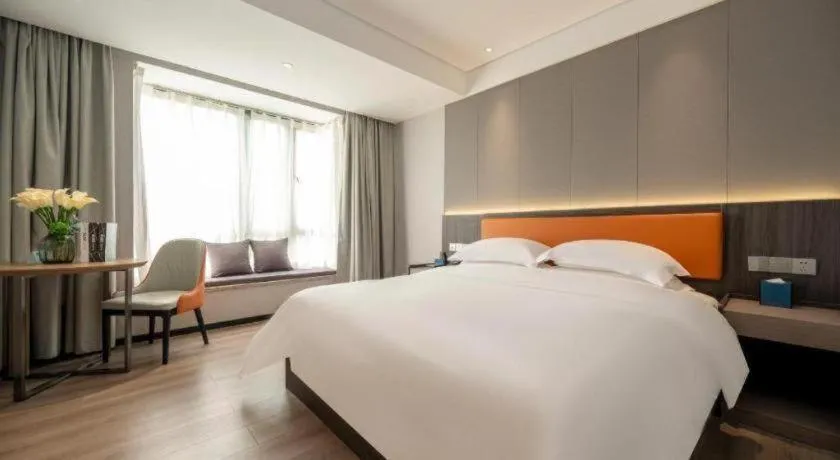 Bed in Echarm Hotel Zhanjiang Zhanchuan Avenue Wanda Plaza
