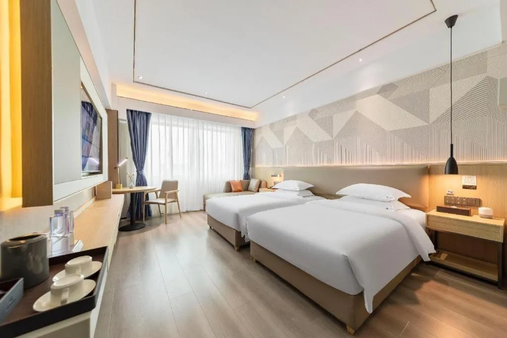 Bed in Borrman Hotel Wanning Wenming Road High-speed Railway Station