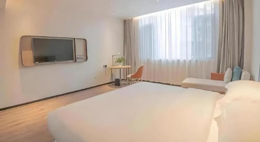 Bed in Echarm Hotel Zigong Machishui Wanda Plaza