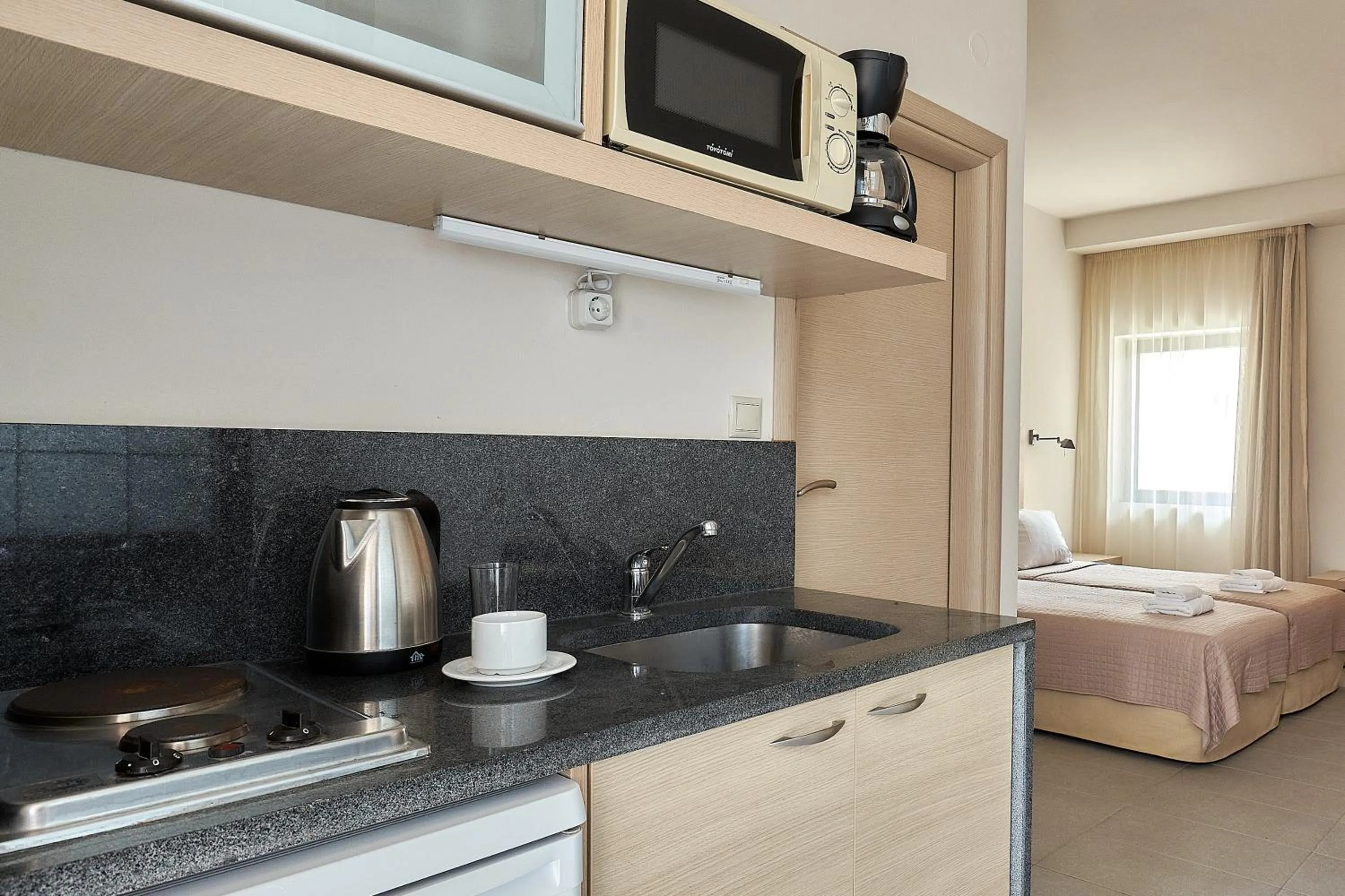 kitchen, Bed in Creteco Hotel & Suites