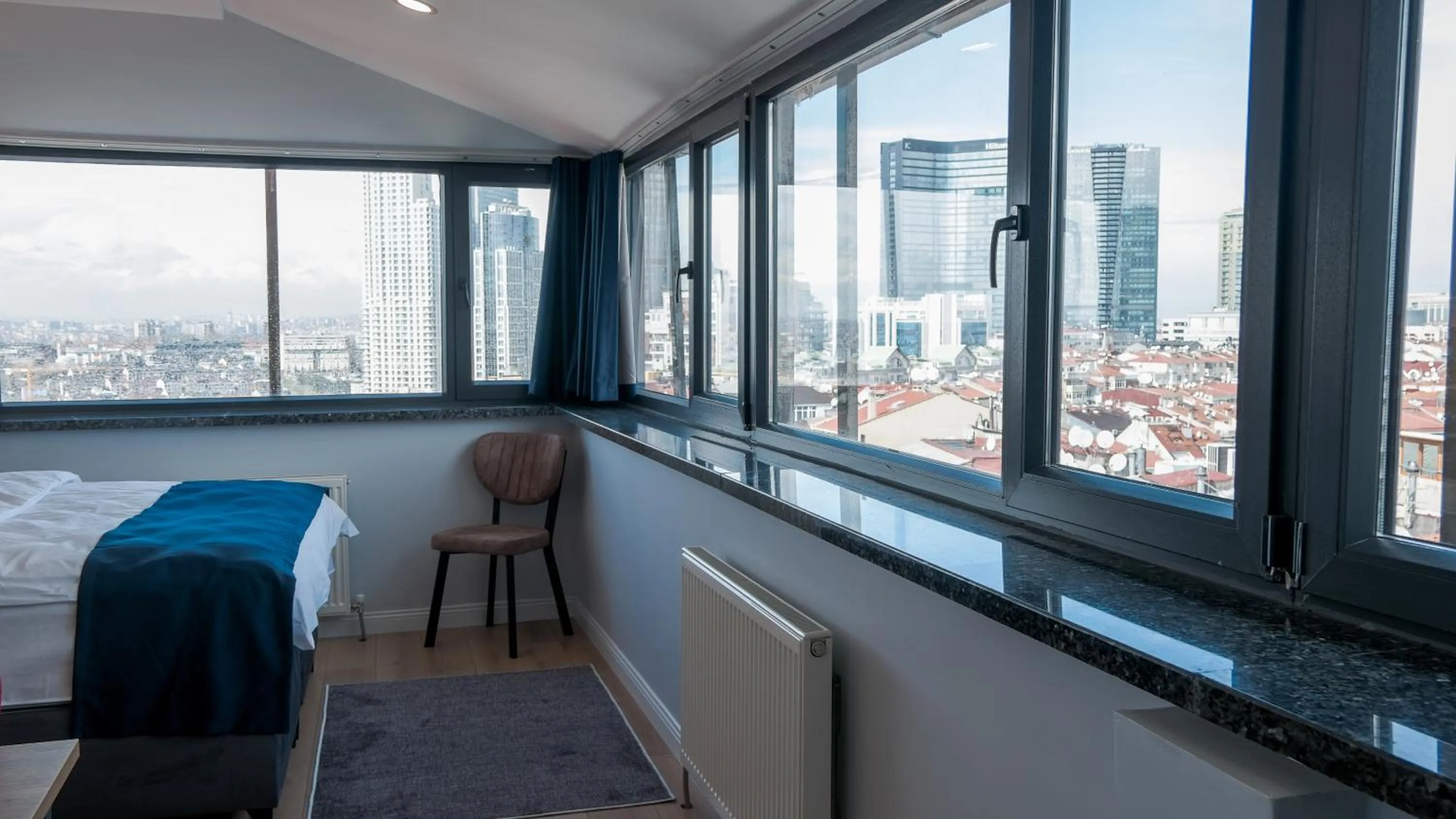 Photo of the whole room, Bed in The Blue Suites