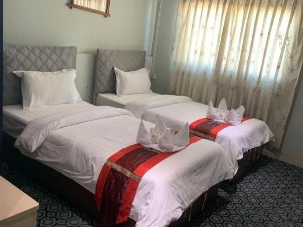 Bed in New Lao Paris Hotel