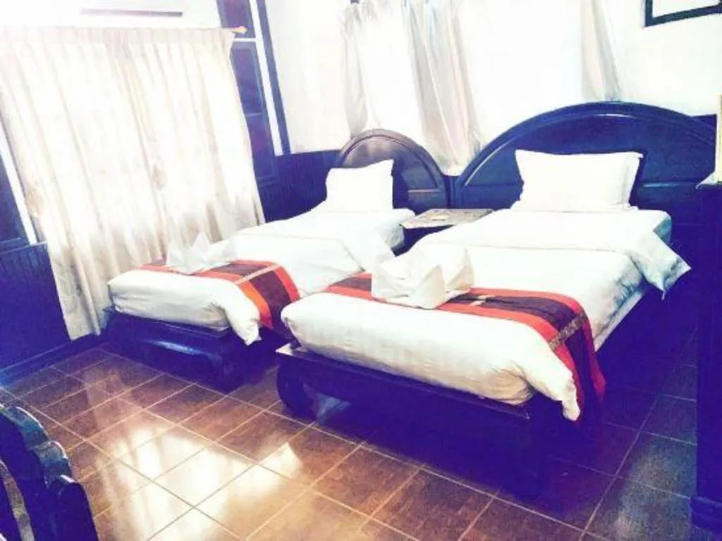 Bed in New Lao Paris Hotel