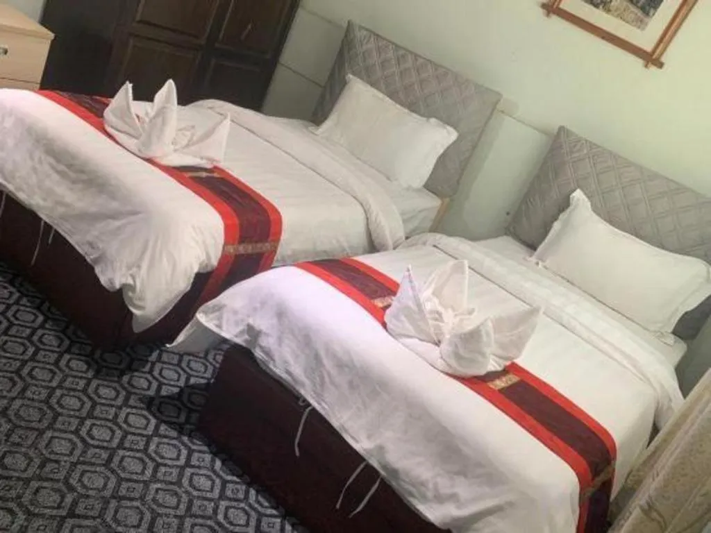 Bed in New Lao Paris Hotel