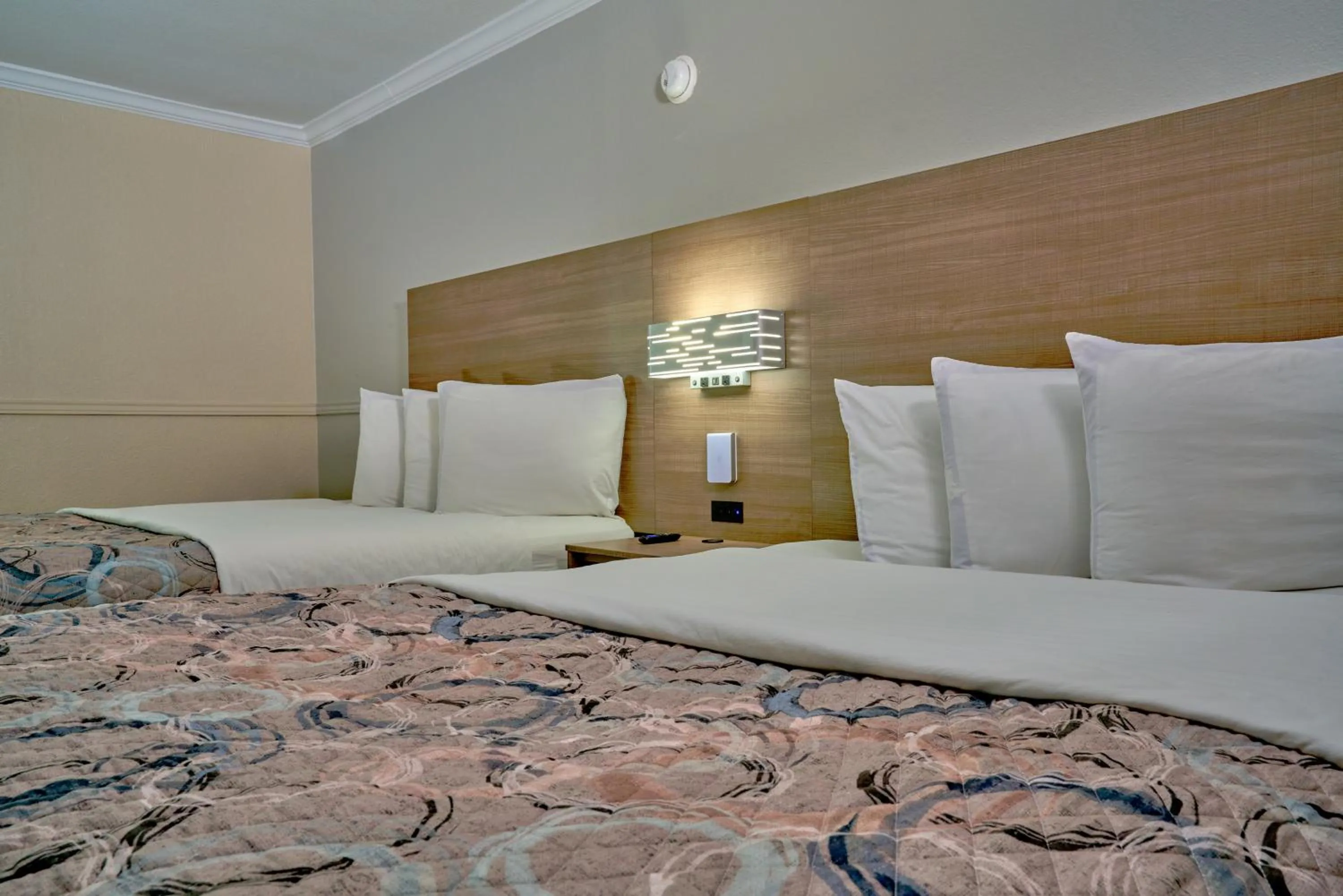 Bed in Family Garden Inn & Suites