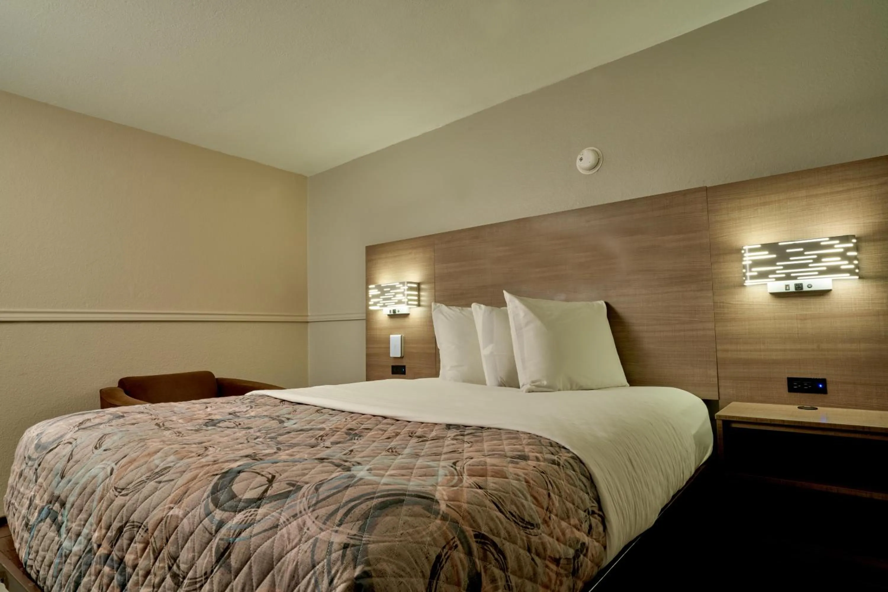 Bed in Family Garden Inn & Suites