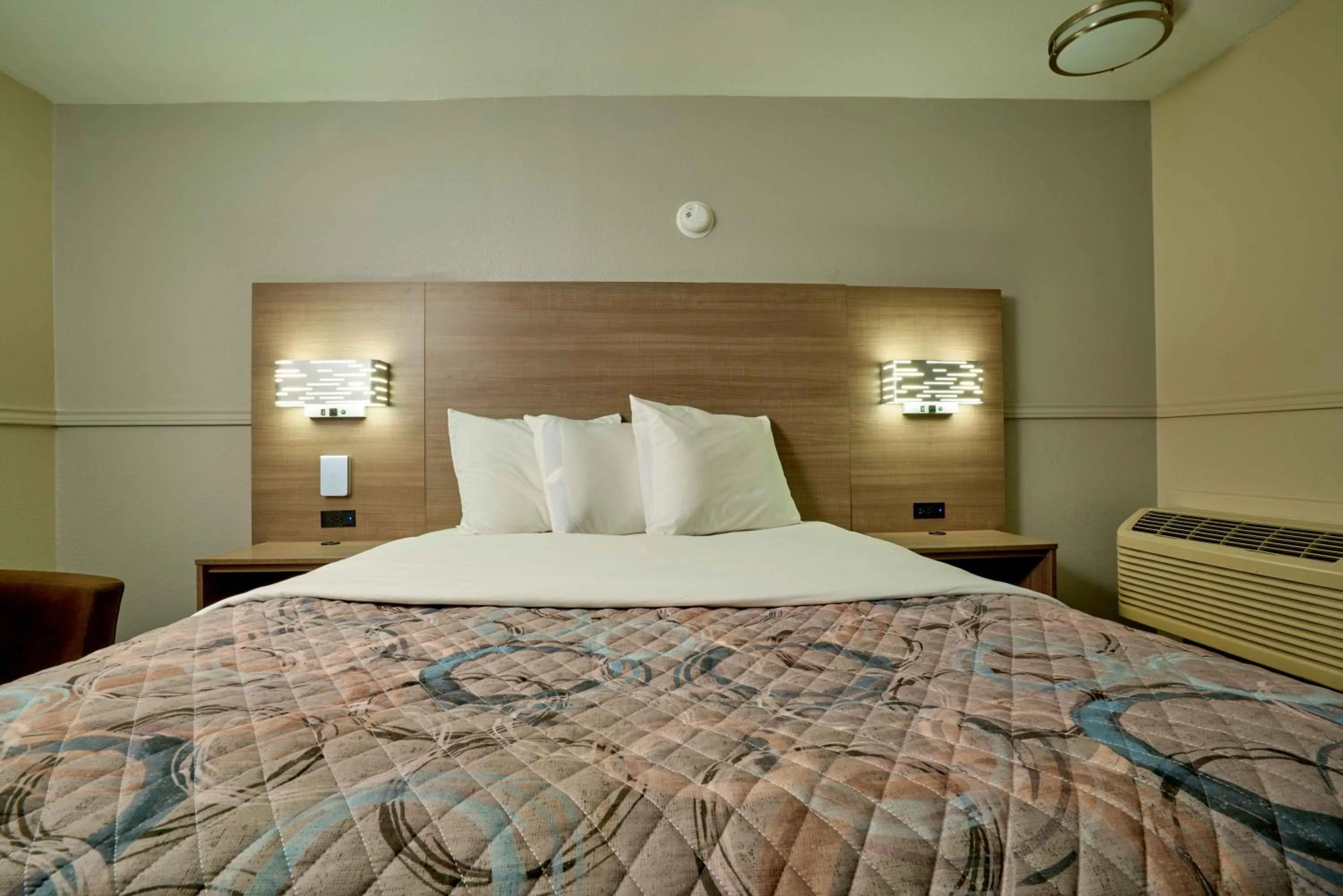 Bed in Family Garden Inn & Suites