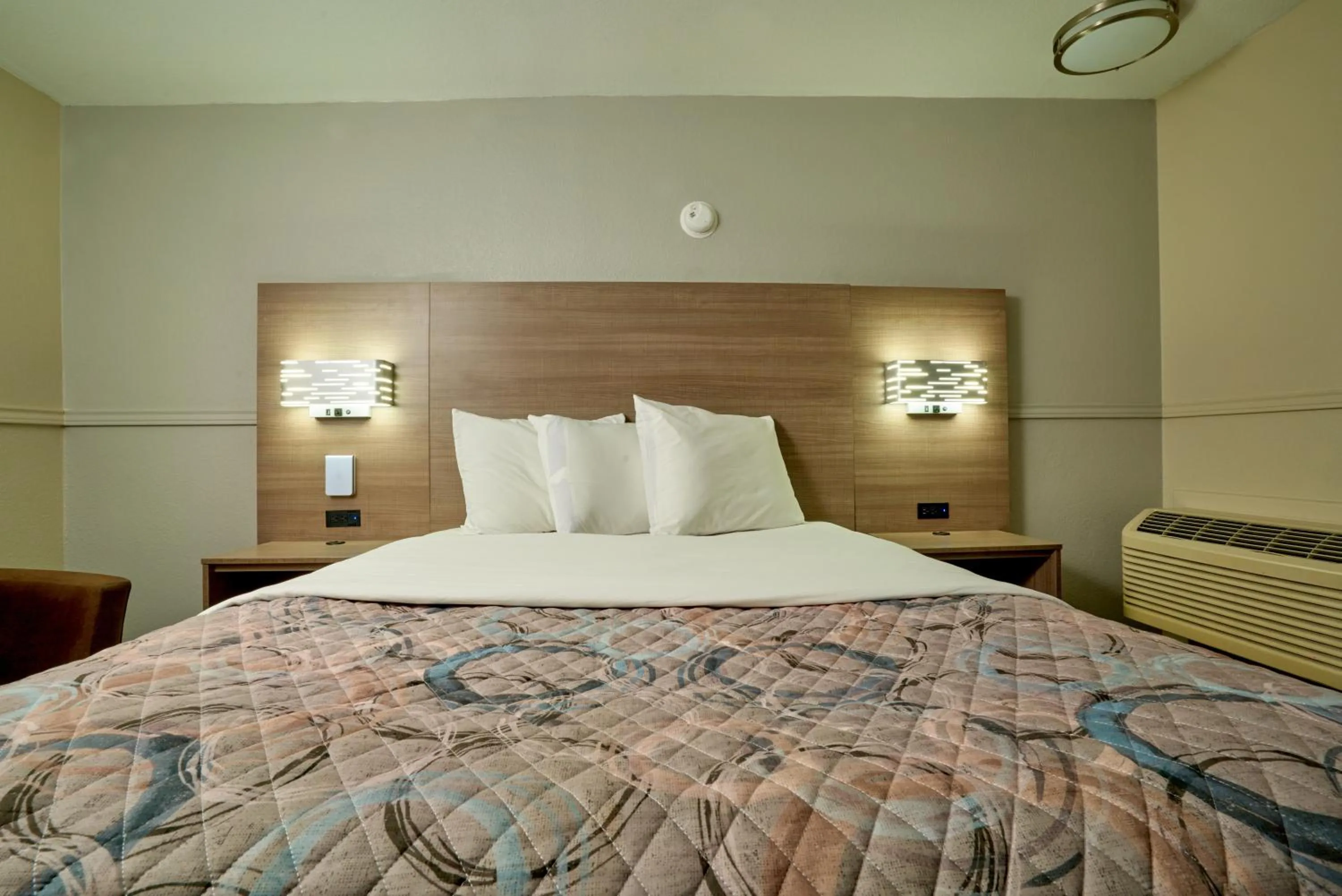 Bed in Family Garden Inn & Suites