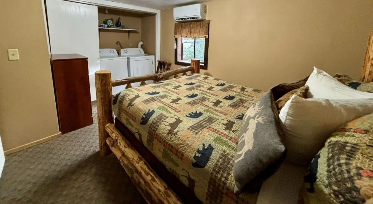 Bed in Riverfront Motel & Cabins