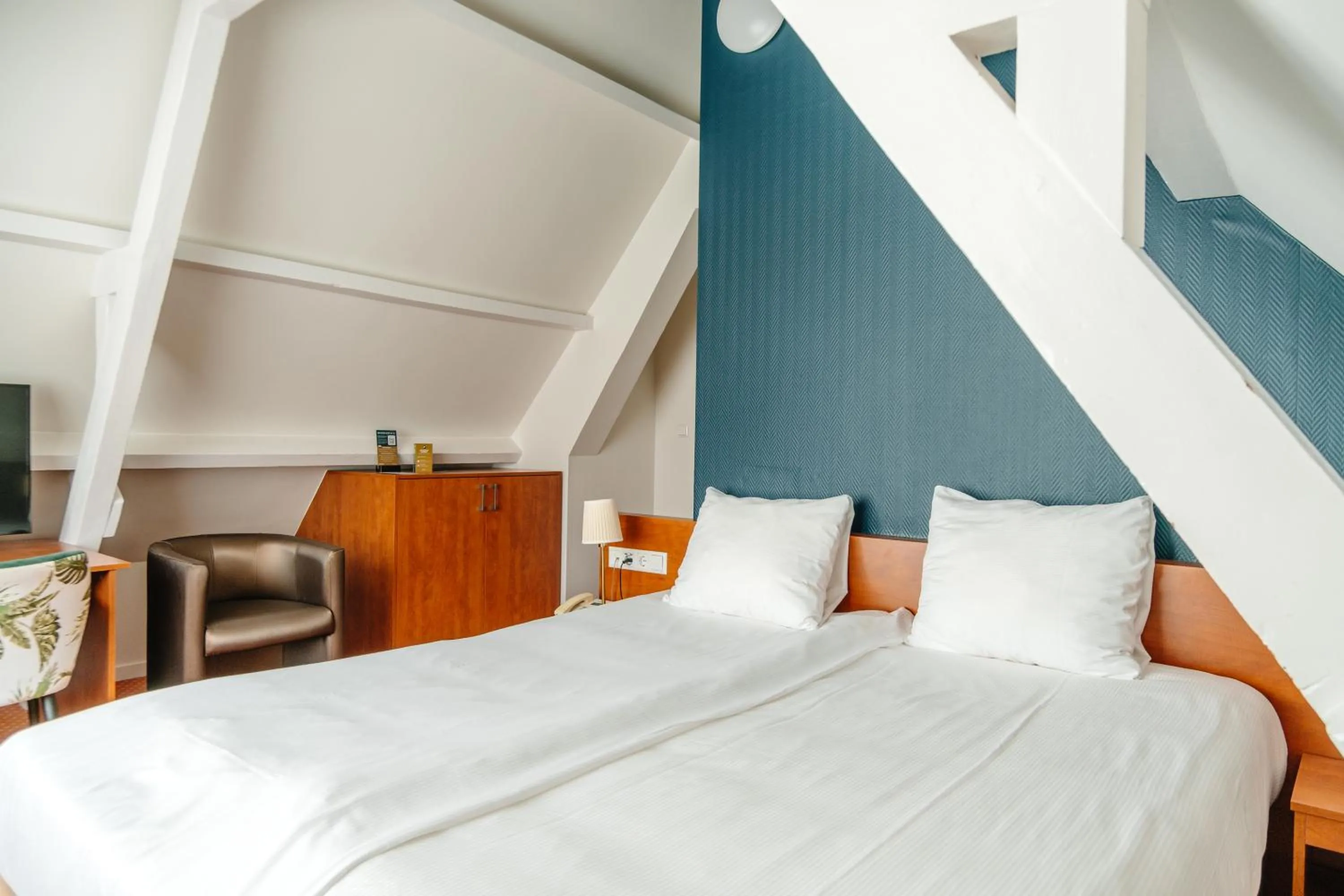 Bed in Ambassador City Centre Hotel