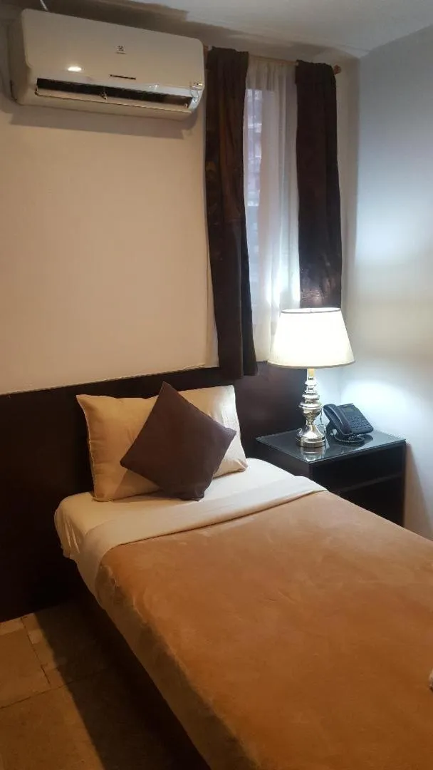 Bed in Gervasia Hotel Makati