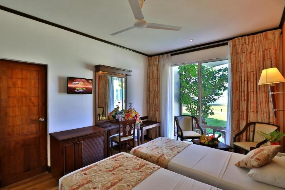 Bed in Hibiscus Beach Hotel & Villas