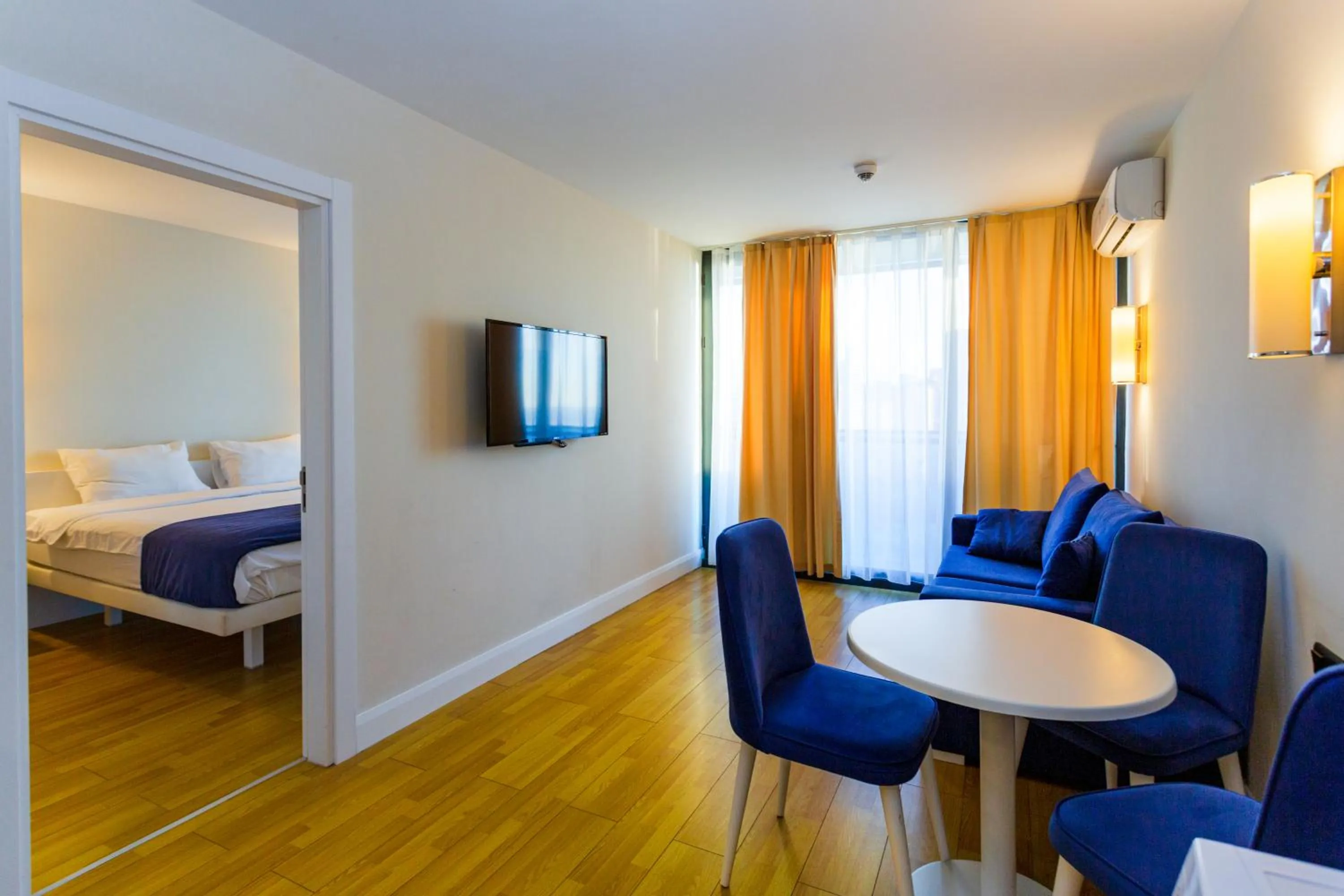 Communal lounge/ TV room, Bed in Orbi City Hotel