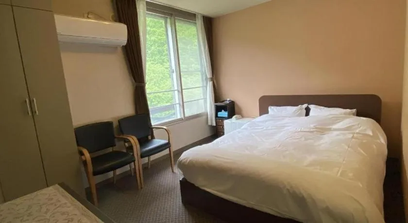 Bed in Ryobou Hanaemi Hotel