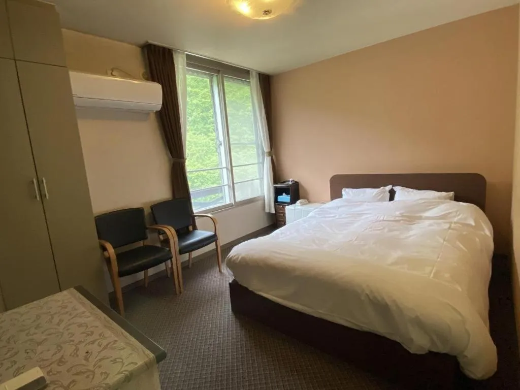 Bed in Ryobou Hanaemi Hotel