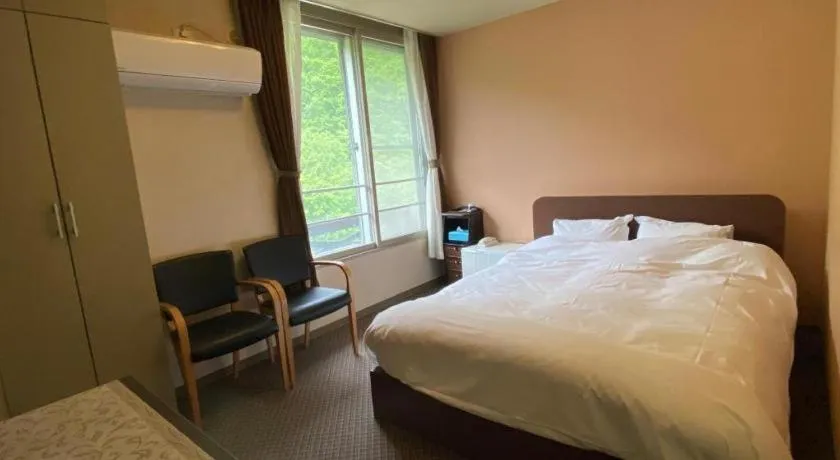 Bed in Ryobou Hanaemi Hotel