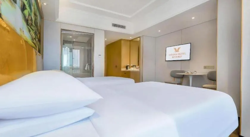 Bed in Vienna Hotel Chongqing Yangjiaping Pedestrian Street Light Railway Station
