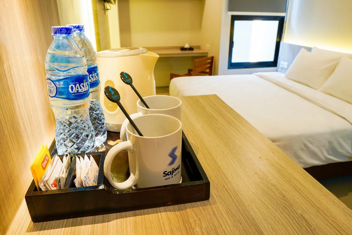 Bed in Sajiwa Inn and Suite Hotel