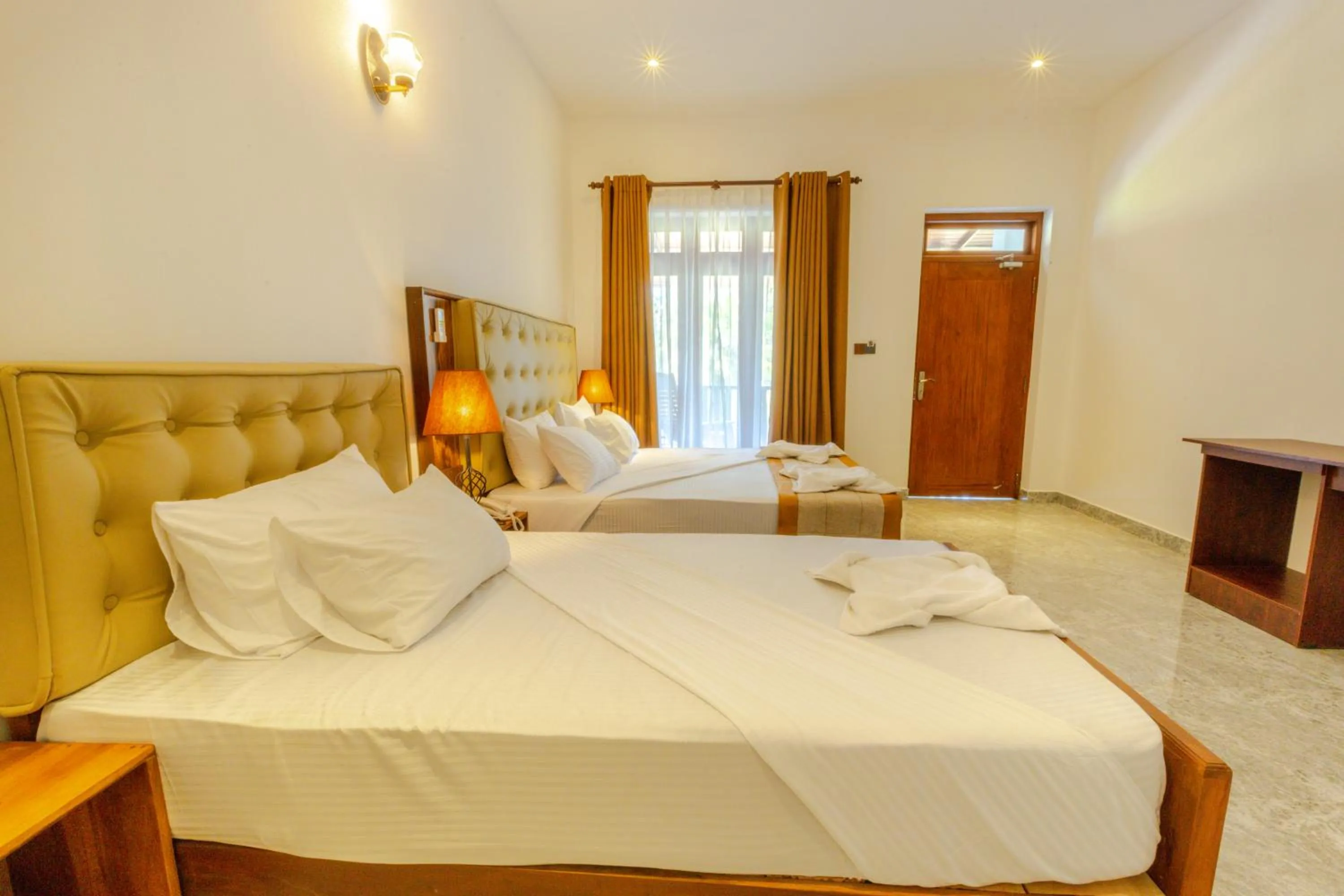 Bed in Elysia Sigiriya Hotel