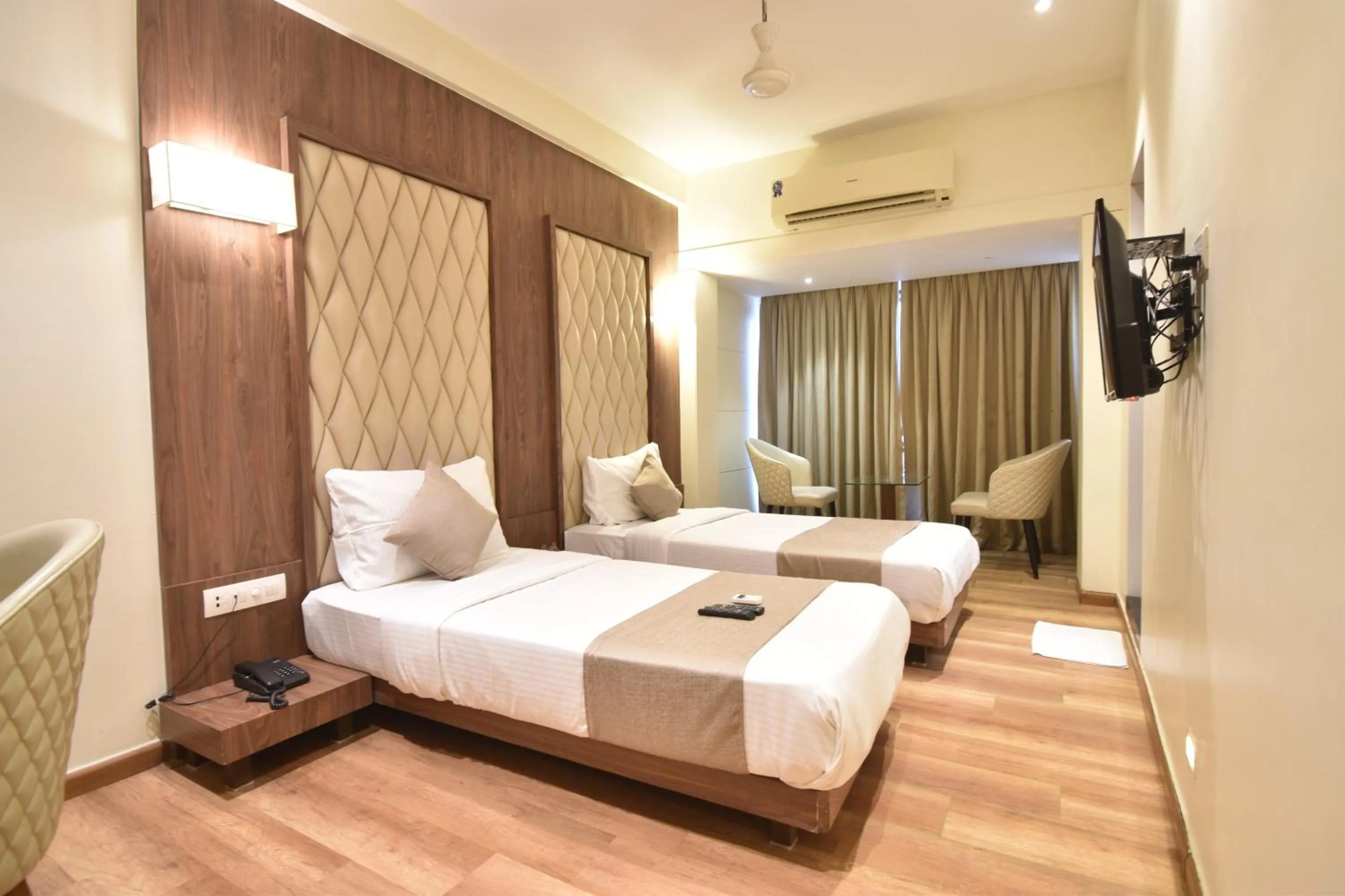 Seating area, Bed in The Aarya A Smart Business Hotel