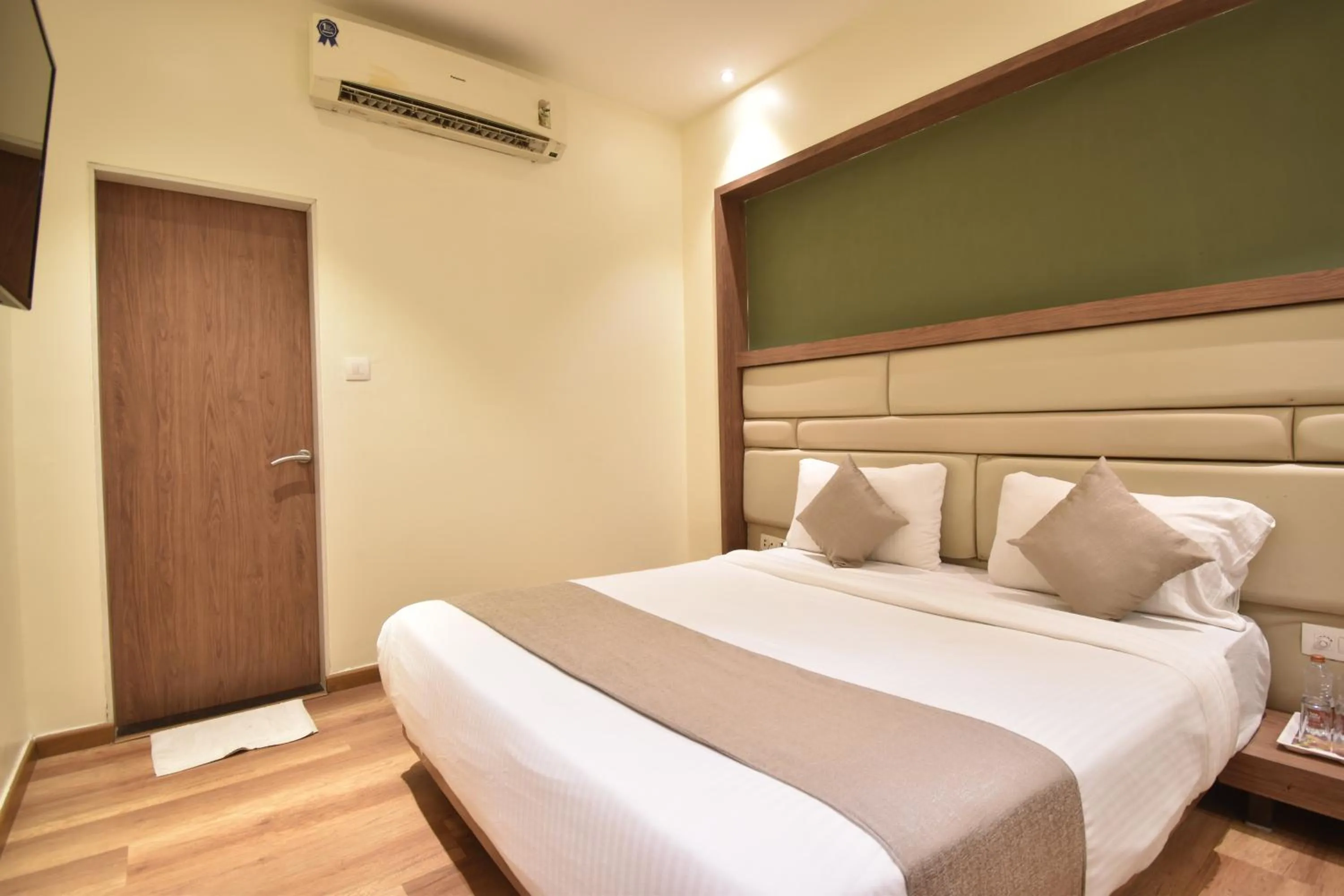 Bed in The Aarya A Smart Business Hotel