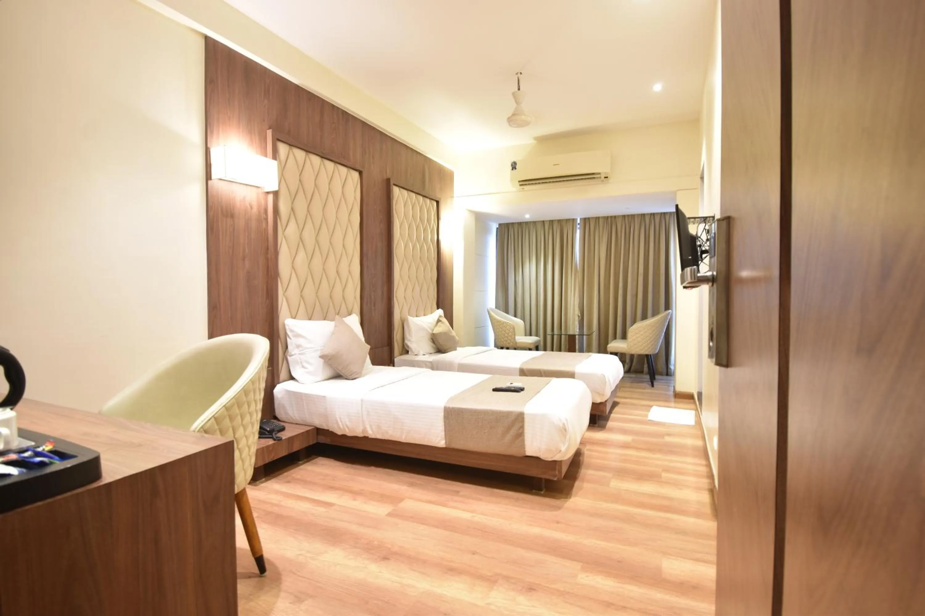 Seating area, Bed in The Aarya A Smart Business Hotel