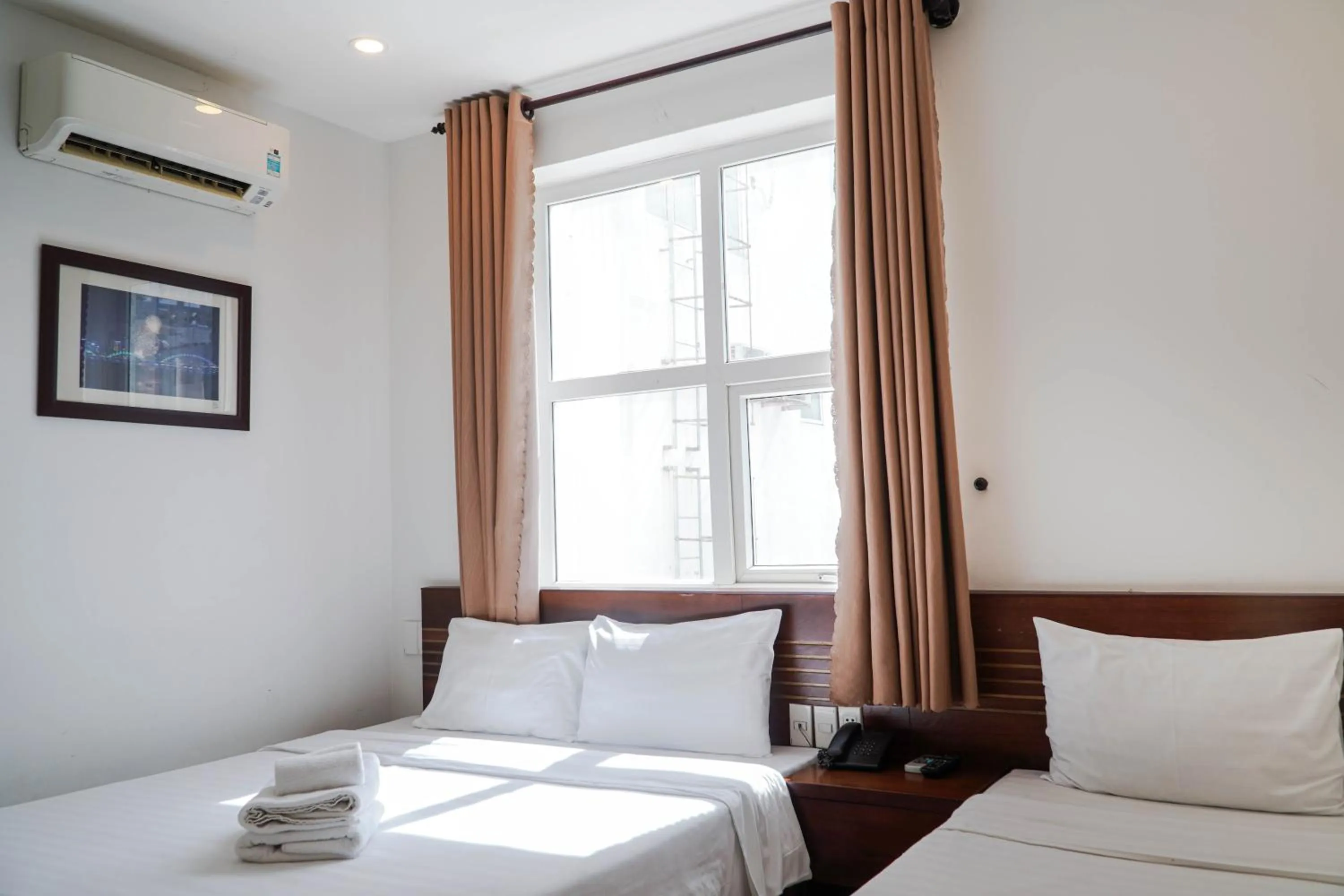 Bed in Golden Light Da Nang Hotel