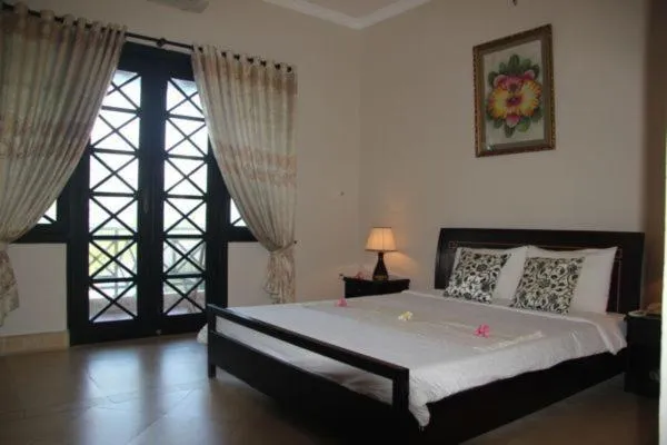 Bed in Orchid Boutique Beach Resort
