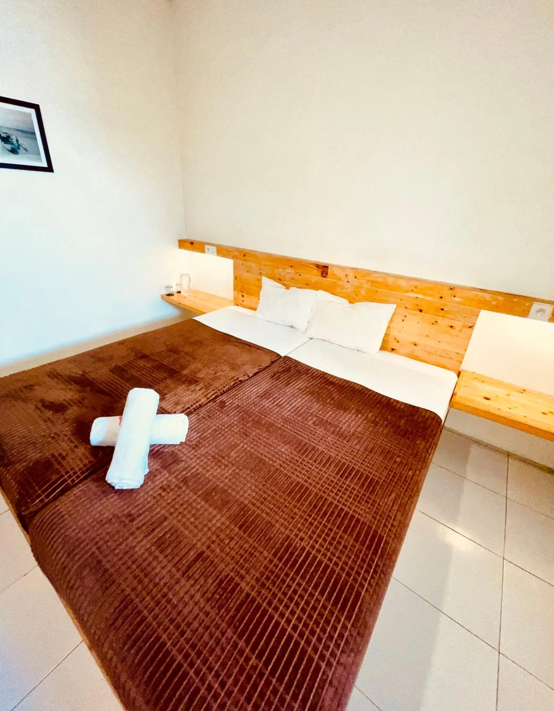 Bed in TANAWU AIRPORT HOTEL LOMBOK