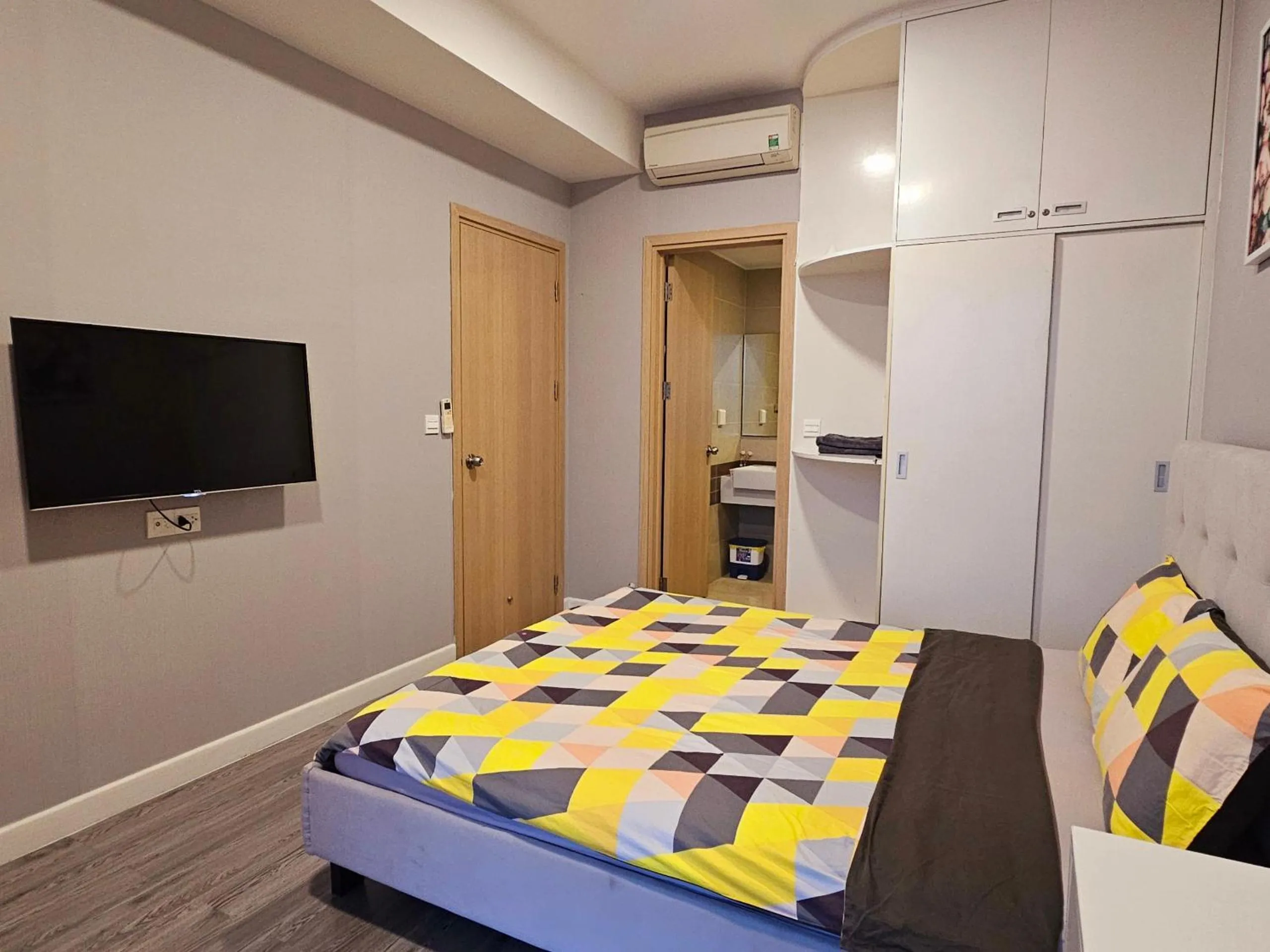 Bed, TV/Entertainment Center in Local Home Pham Ngu Lao